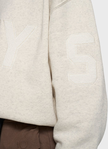 statement sweater logo patch | soft white melee