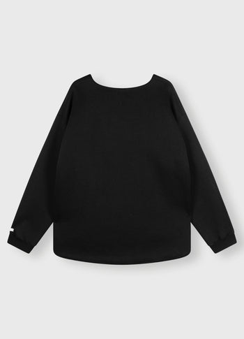 raw edge statement sweater | black
